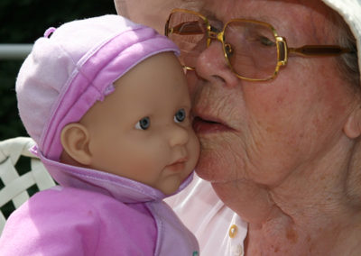 elder lady with baby doll